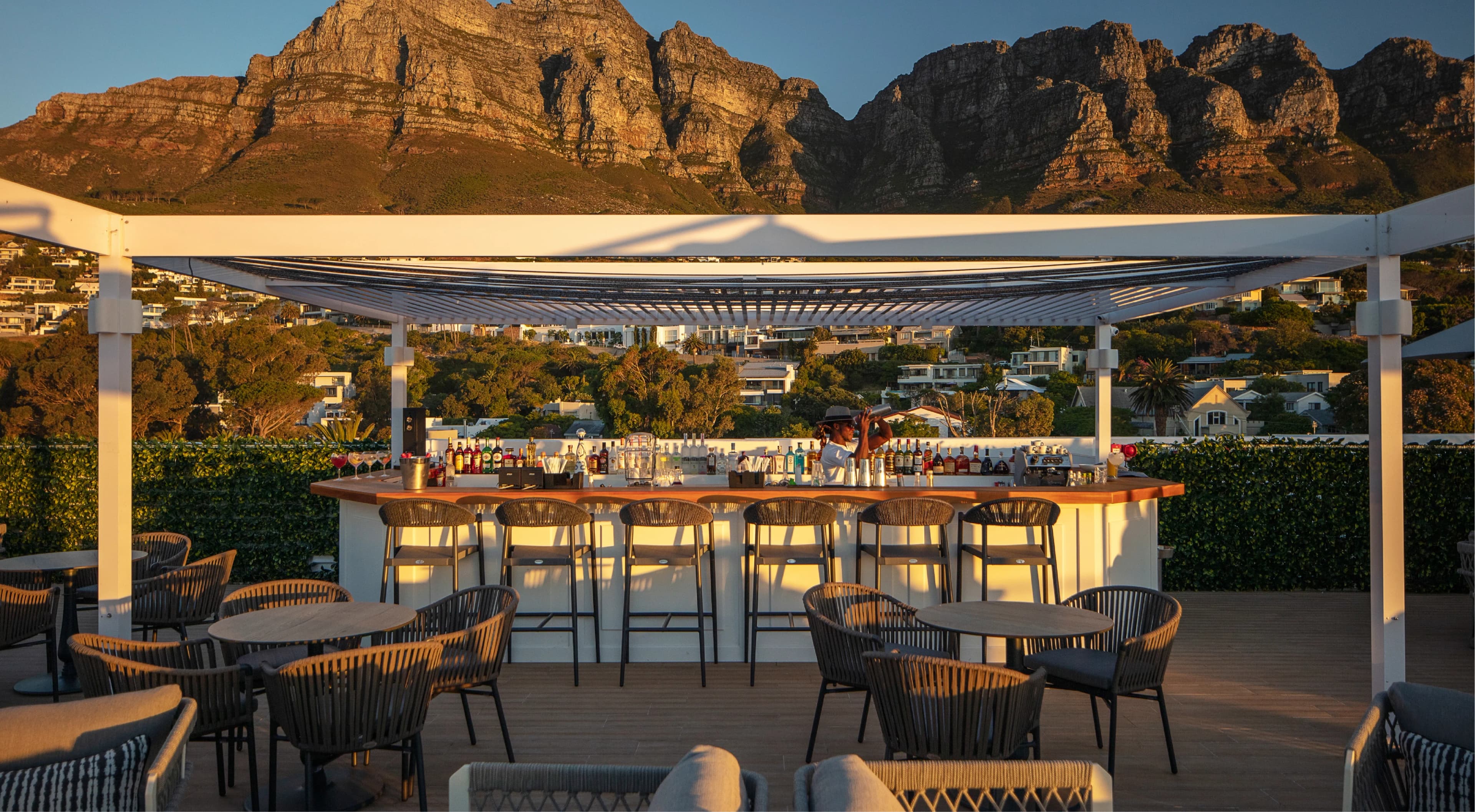 Baptiste Rooftop Bar & Lounge bar with barman shaking a cocktail 