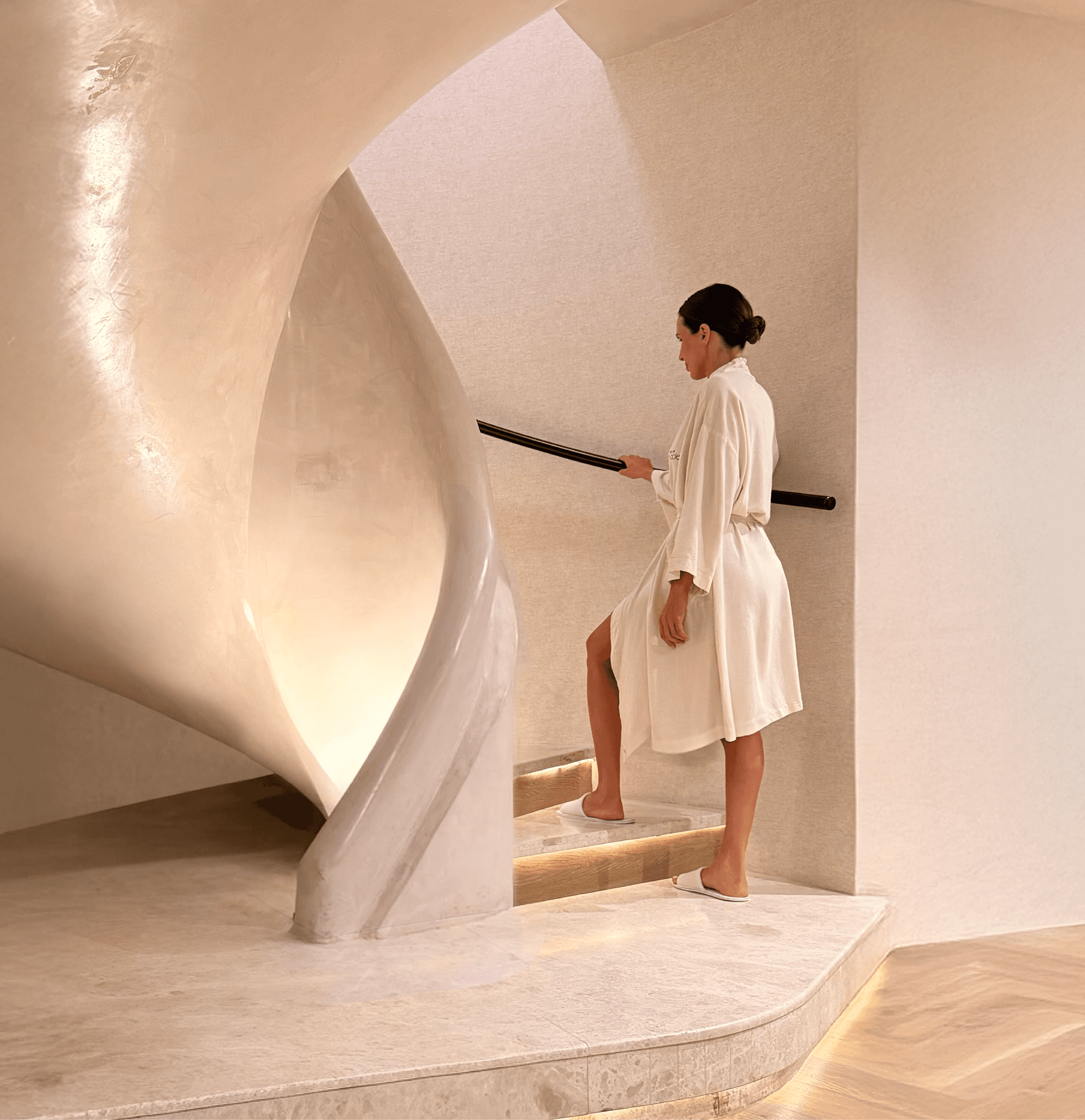 Spa at The Cole girl walking up spiral staircase