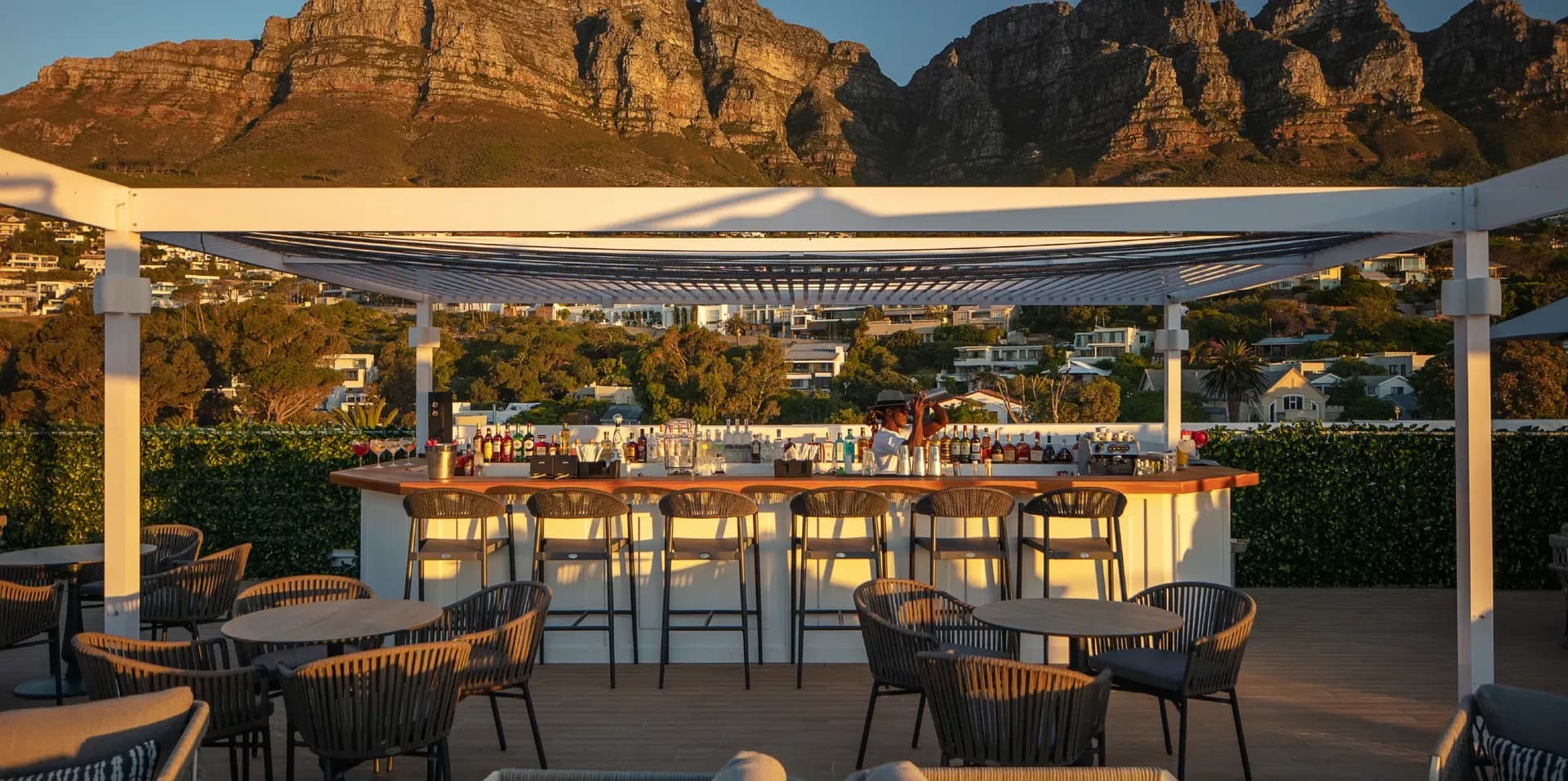 Baptiste Rooftop Bar & Lounge bar with barman shaking a cocktail